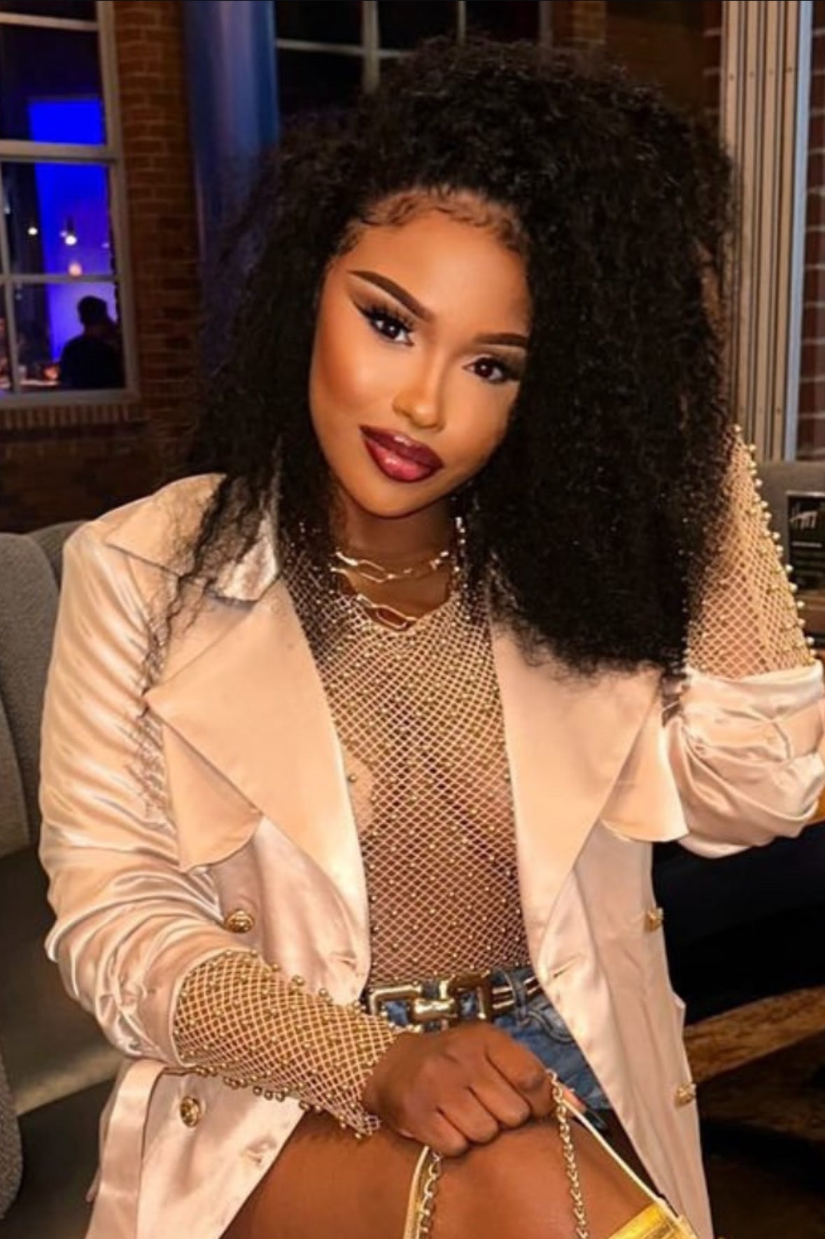 model wearing Brazilian Curly wig close up